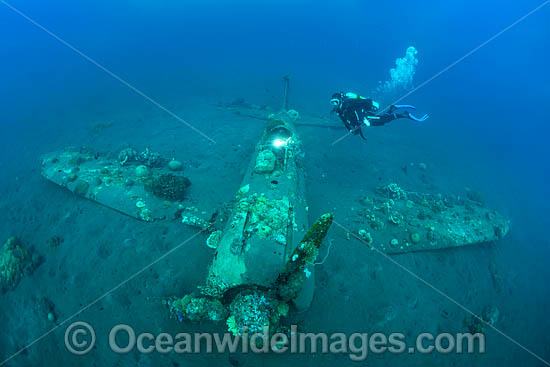 Divers exploring a WWll Japanese Zero fighter plane sitting intact and upright in 17m of water. Kimbe Bay, Papua New Guinea. Photo - Gary Bell Divers exploring a WWll Japanese Zero fighter plane sitting intact and upright in 17m of water. Kimbe Bay, Papua New Guinea. Photo - Gary Bell