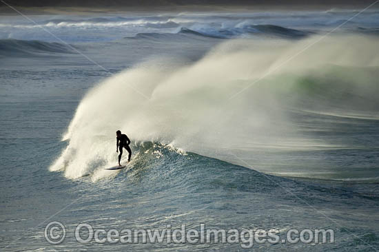 Surfer riding waves photo