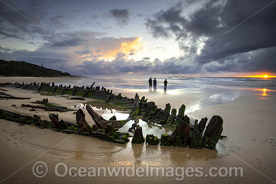 Historic Shipwreck 'Buster' on Woolgoolga beach at sunset, New South Wales. Vessel was blown ashore & beached during a violent storm in Feb 1893. Class: Barquentine. Construction: Timber single deck & 3 masts. Built: Nova Scotia, Canada 1884. Length - 129 Photo - Gary Bell