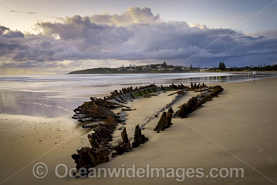 Historic Shipwreck 'Buster' on Woolgoolga beach, New South Wales. Vessel was blown ashore & beached during a violent storm in Feb 1893. Class: Barquentine. Construction: Timber single deck & 3 masts. Built: Nova Scotia, Canada 1884. Length - 129 ft Photo - Gary Bell Historic Shipwreck 'Buster' on Woolgoolga beach, New South Wales. Vessel was blown ashore & beached during a violent storm in Feb 1893. Class: Barquentine. Construction: Timber single deck & 3 masts. Built: Nova Scotia, Canada 1884. Length - 129 ft Photo - Gary Bell