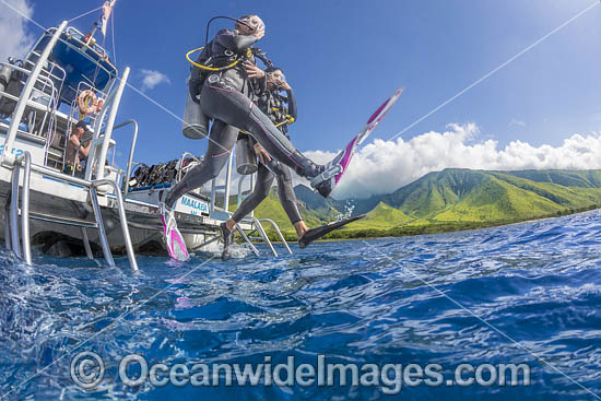 Divers stepping off boat photo