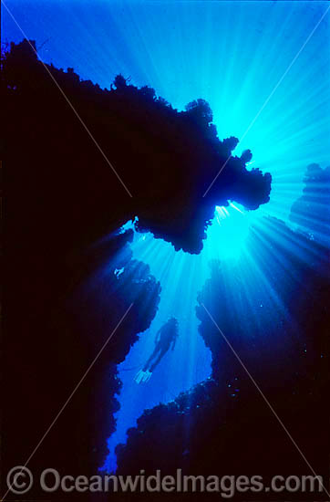 Silhouette of Scuba Diver in undersea cave photo