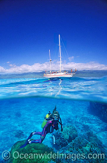 Scuba Diver beneath sailing yacht photo Scuba Diver beneath sailing yacht photo