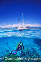 Scuba Diver beneath sailing yacht Photo - Gary Bell