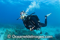 Diver exploring a tropical coral reef, wearing an underwater communications breathing mask. Photo taken at Heron Island, Great Barrier Reef, Australia.