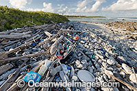Marine pollution rubbish trash garbage comprising of plastic bottles, footwear, timber and fishing implements, washed ashore by tidal movement on a remote beach - probably drifting in from Indonesia. Cocos (Keeling) Islands, Indian Ocean, Australia.