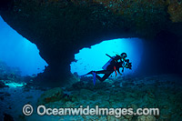 Underwater photographer exploring and photographing a tropical coral reef cave at Christmas Island, Indian Ocean, Australia.