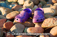 Beach Scene - reef walking shoes resting on beach rock exposed during low tide. Hayman Island, Whitsunday Islands, Queensland, Australia