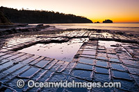 Tessellated Pavement, during sunrise. This natural rock pavement bears this name because it is fractured into polygonal blocks that resemble tiles of a mosaic floor. Eaglehawk Neck, Tasman Peninsula, Tasmania, Australia.