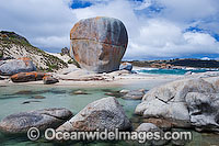 Castle Rock, a huge lichen (Caloplaca sp.) covered coastal granite boulder surrounded by smaller granite boulders. Flinders Island, Tasmania, Australia
