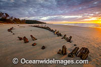 Historic Shipwreck 'Buster' exposed at sunrise on Woolgoolga beach, New South Wales, Australia. This 3 mast timber barque was blown ashore and beached during a violent storm in February 1893.