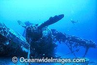 Scuba Diver exploring wreck of World War II Japanese bi-plane. New Britain Island, Papua New Guinea.