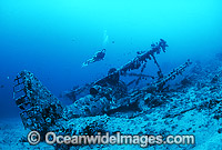 Scuba Diver exploring a wreck of World War II Japanese bi-plane. New Britain Island, Papua New Guinea.