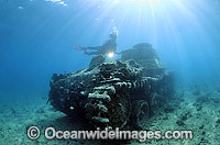 Scuba Diver exploring a wreck of World War II Japanese tanks. New Britain Island, Papua New Guinea. Within the Coral Triangle.