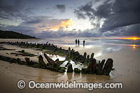 Historic Shipwreck 'Buster' on Woolgoolga beach at sunset, New South Wales. Vessel was blown ashore & beached during a violent storm in Feb 1893. Class: Barquentine. Construction: Timber single deck & 3 masts. Built: Nova Scotia, Canada 1884. Length - 129