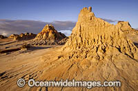 Sunset picture of eroded sand and mud dunes, known as 'Walls of China', situated on the fringe of Lake Mungo. Mungo World Heritage National Park, south-western New South Wales, Australia