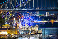 Sydney Harbour Bridge, Luna Park and City decorated in light during Vivid Sydney's 2018 festival of light, music and ideas. Sydney, New South Wales, Australia.
