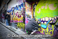 Graffiti Artist at work in Hosier Lane, also known as Graffiti Lane. Melbourne, Victoria, Australia.
