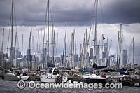 Yachts berthed at Williamstown Jetty, with Melbourne city in the background. Williamstown, Victoria, Australia.