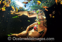 Woman exploring a freshwater river with snorkeling equipment. Mulgrave River, near Cairns, north Queensland, Australia