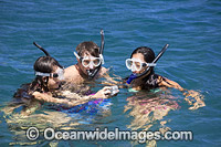 Snorkel divers exploring a tropical coral reef. Photo taken in Hawaii, USA.