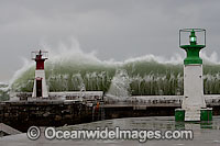 Wave breaking over lighthouse Photo - Chris and Monique Fallows