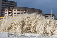 Wave breaking over house Photo - Chris and Monique Fallows