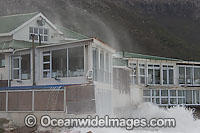 Wave breaking over house Photo - Chris and Monique Fallows