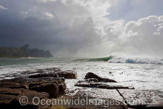 Wave breaking over wall photo Wave breaking over wall photo