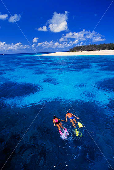 Snorkelers in island lagoon photo Snorkelers in island lagoon photo