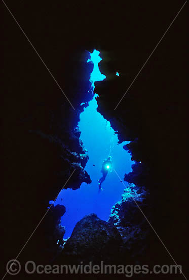 Silhouette of Scuba Diver in undersea cave photo